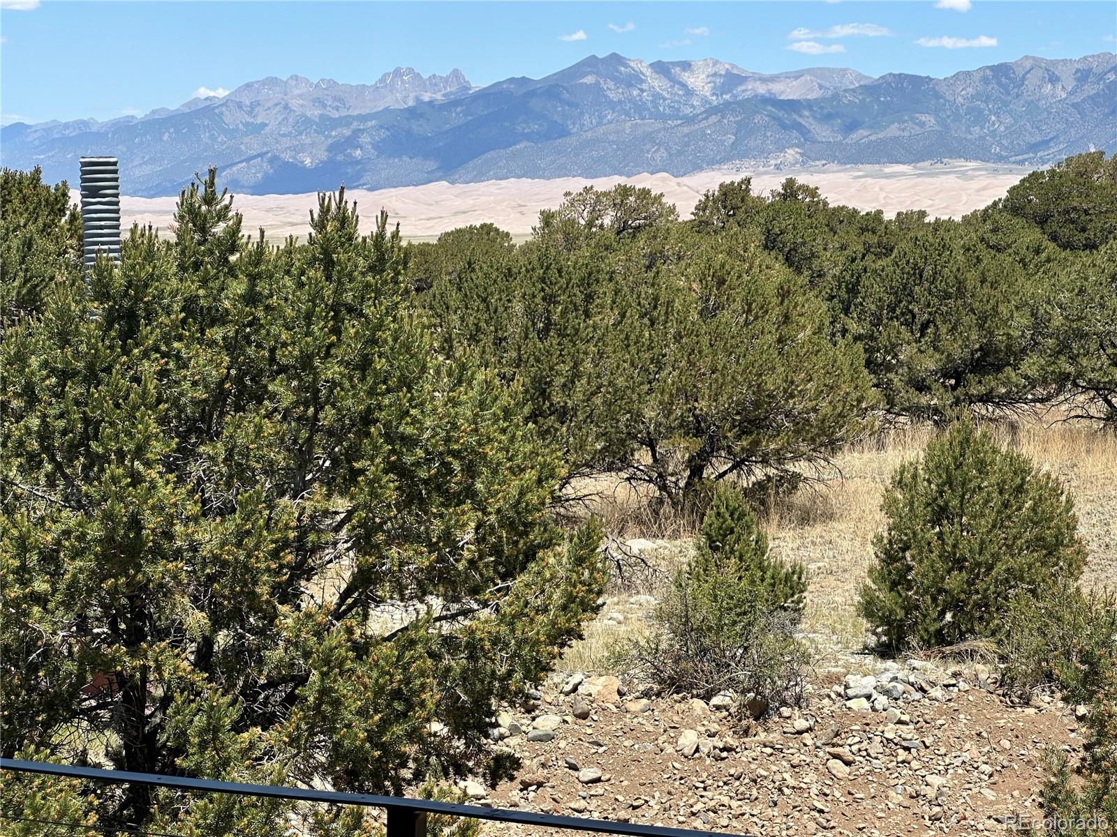 99 Cedar Ridge Road Mosca, CO 81146 - Photo 32 of 36 a view of a city with a mountain