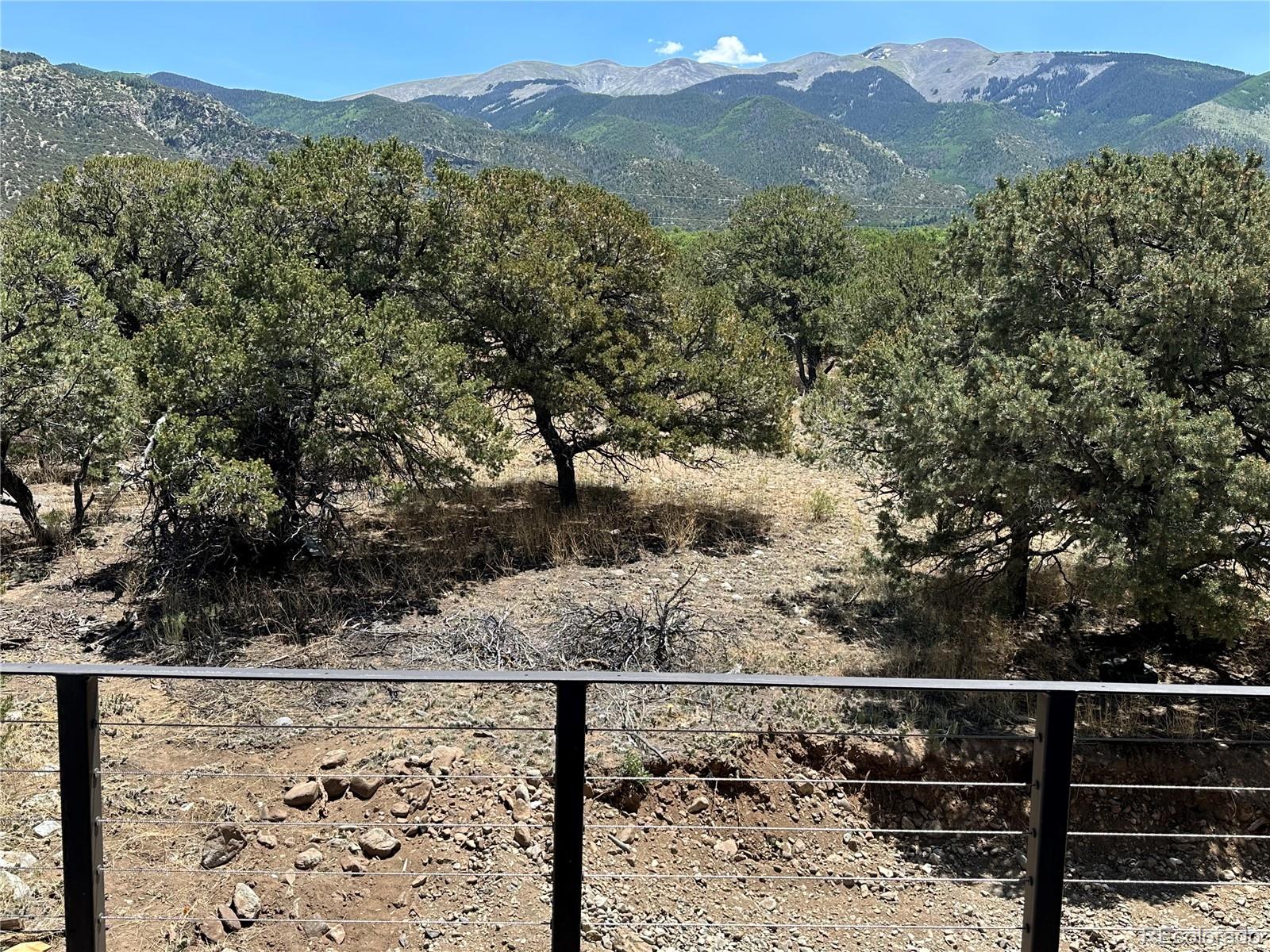 99 Cedar Ridge Road Mosca, CO 81146 - Photo 33 of 36 a view of a forest with a mountain