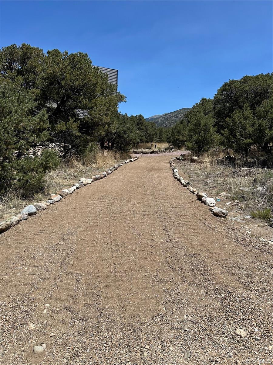 99 Cedar Ridge Road Mosca, CO 81146 - Photo 34 of 36 a view of a road with a building in the background
