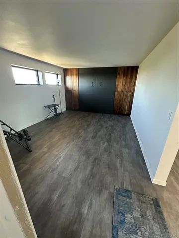 a living room with stainless steel appliances granite countertop a stove and a refrigerator