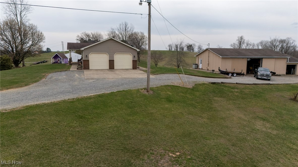 65525 Larrick Ridge Road Cambridge, OH 43725 - Photo 37 of 40 View of yard featuring gravel driveway and an outbuilding