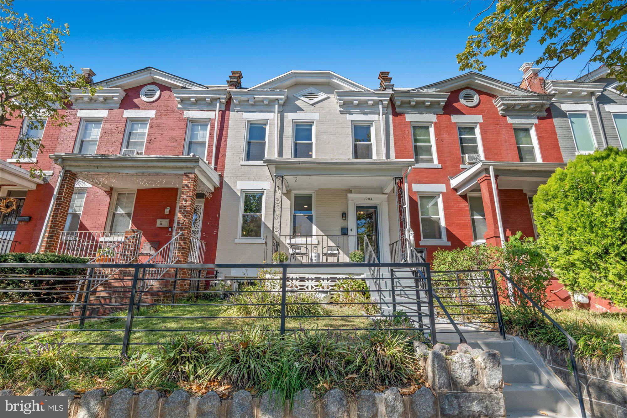 front view of a brick house with a yard