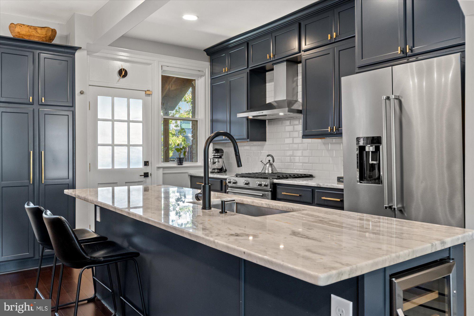 1204 5th Street Northeast Washington, DC 20002 - Photo 11 of 46 a kitchen with granite countertop a sink cabinets and stainless steel appliances