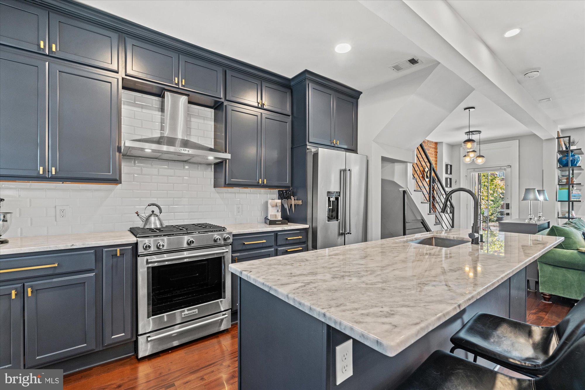 1204 5th Street Northeast Washington, DC 20002 - Photo 13 of 46 a kitchen with stainless steel appliances granite countertop a stove and a refrigerator