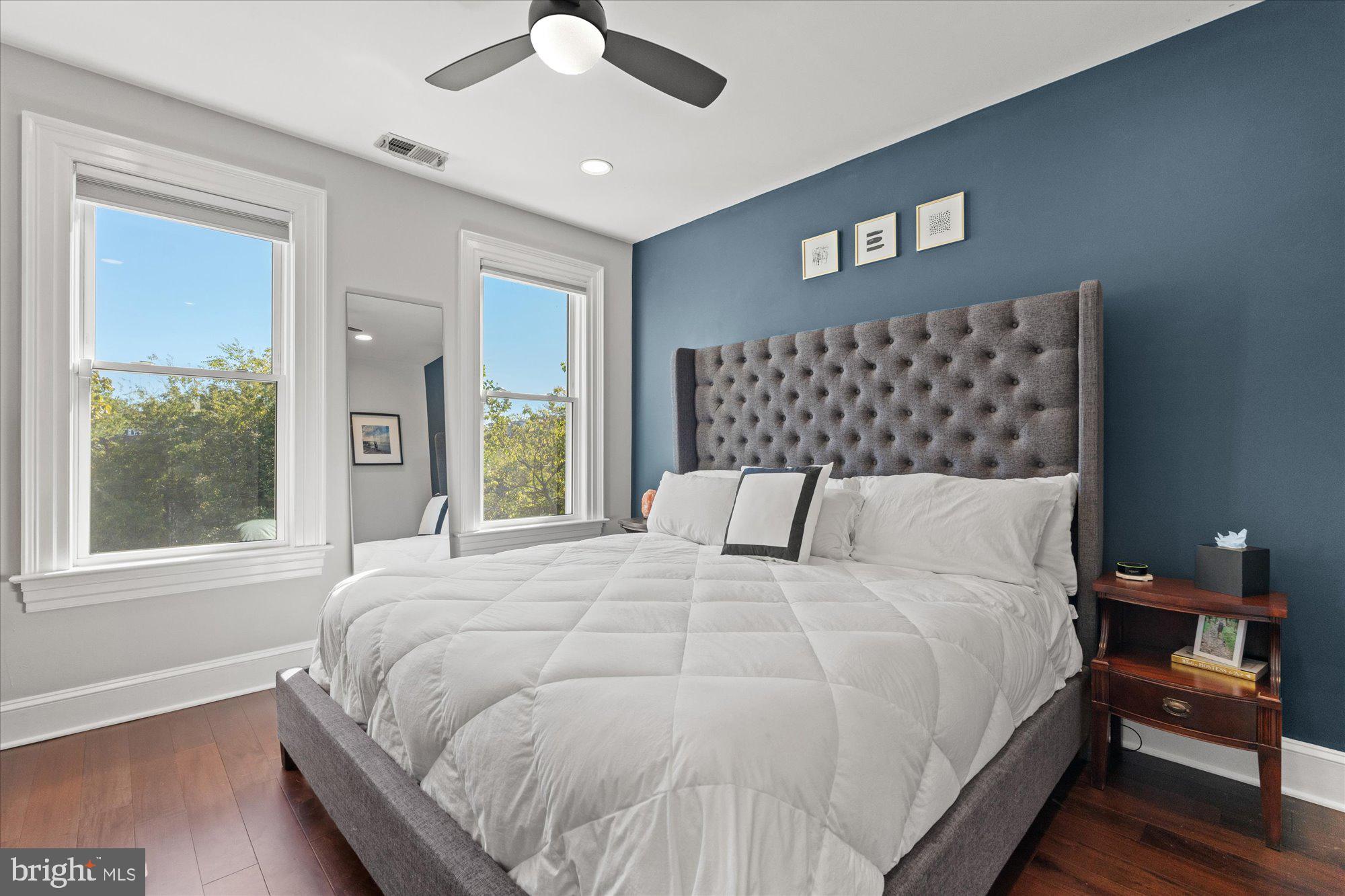 1204 5th Street Northeast Washington, DC 20002 - Photo 16 of 46 a large bedroom with a bed and wooden floor