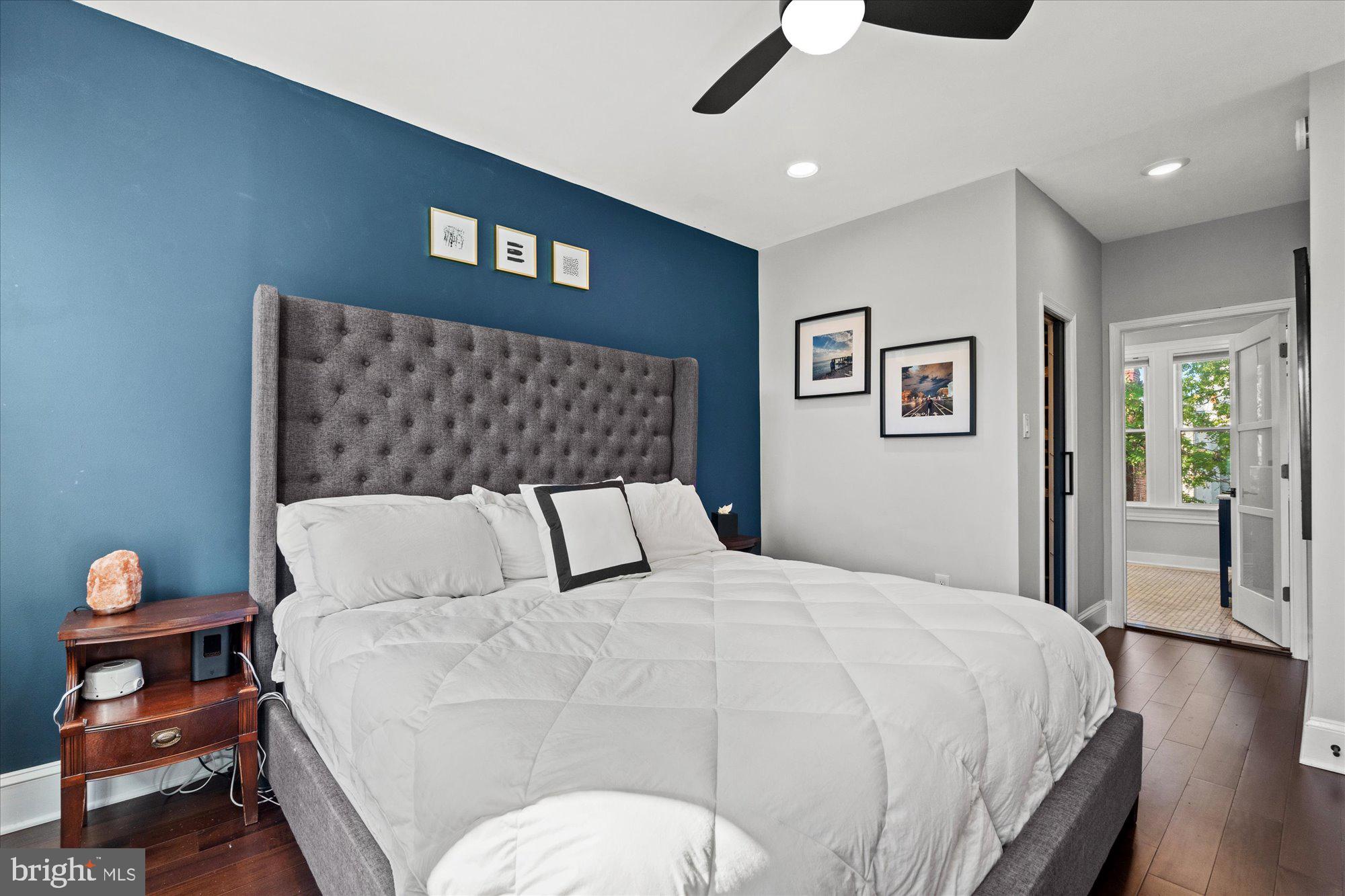 1204 5th Street Northeast Washington, DC 20002 - Photo 17 of 46 a large bed sitting in a bedroom and a chandelier