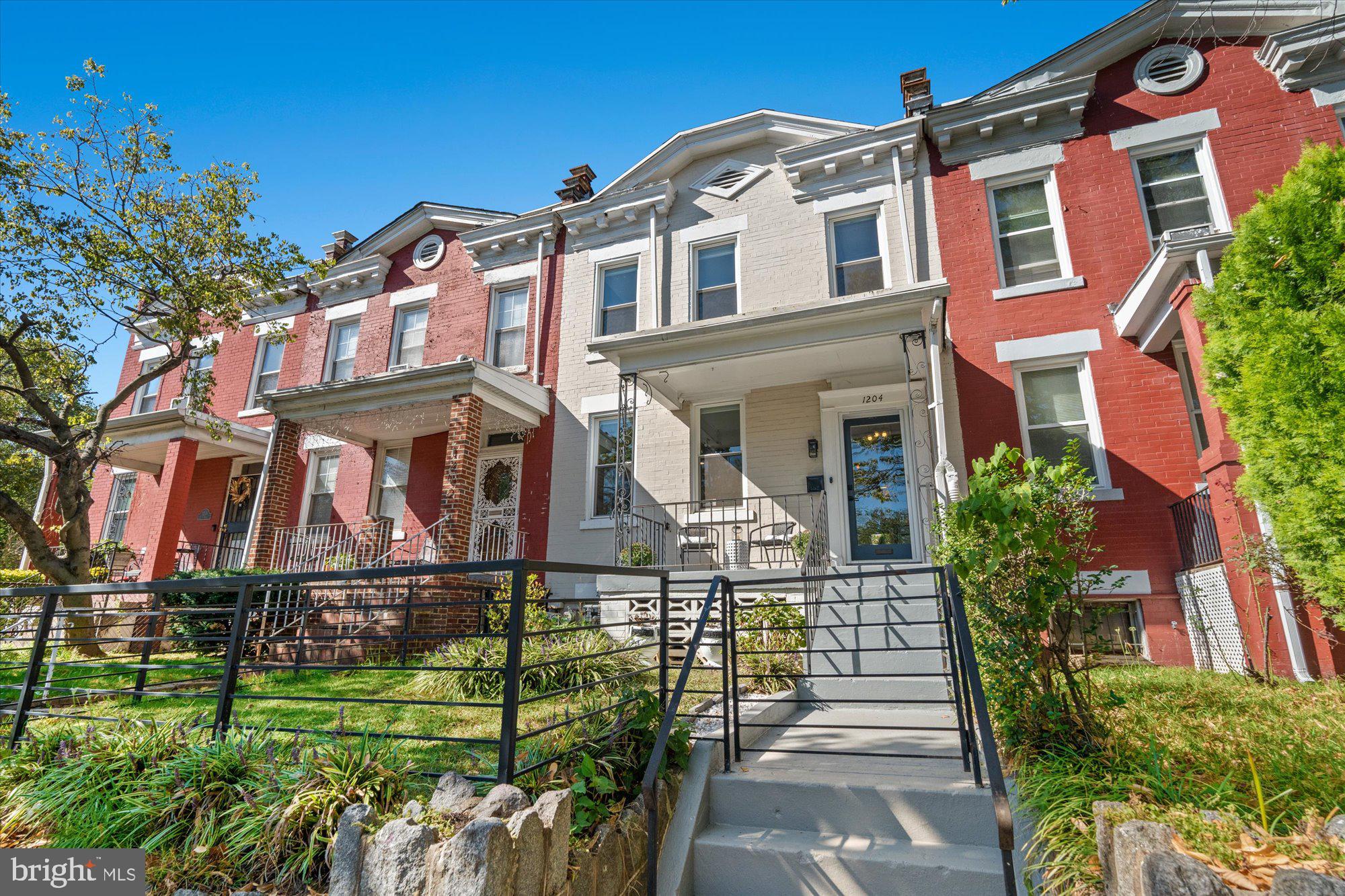 1204 5th Street Northeast Washington, DC 20002 - Photo 2 of 46 front view of a brick house with a yard