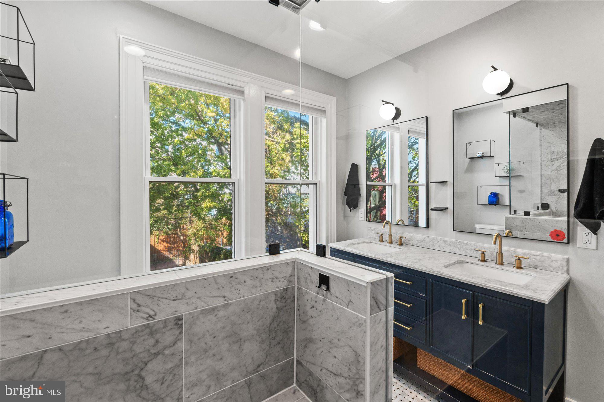 1204 5th Street Northeast Washington, DC 20002 - Photo 22 of 46 a bathroom with a sink double vanity and a large mirror