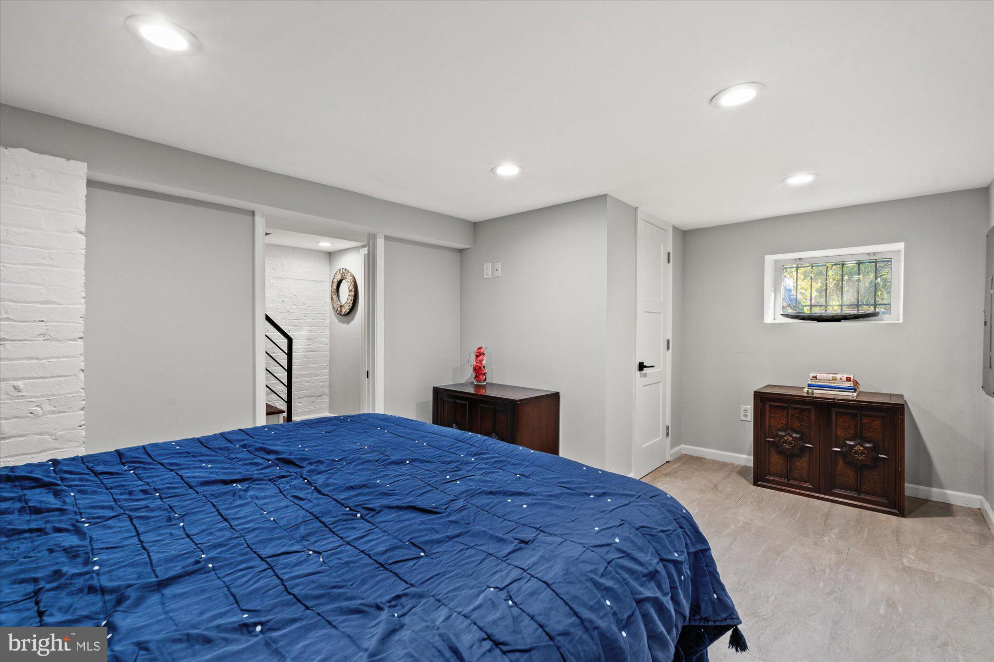 1204 5th Street Northeast Washington, DC 20002 - Photo 31 of 46 a bedroom with a large bed and a chandelier