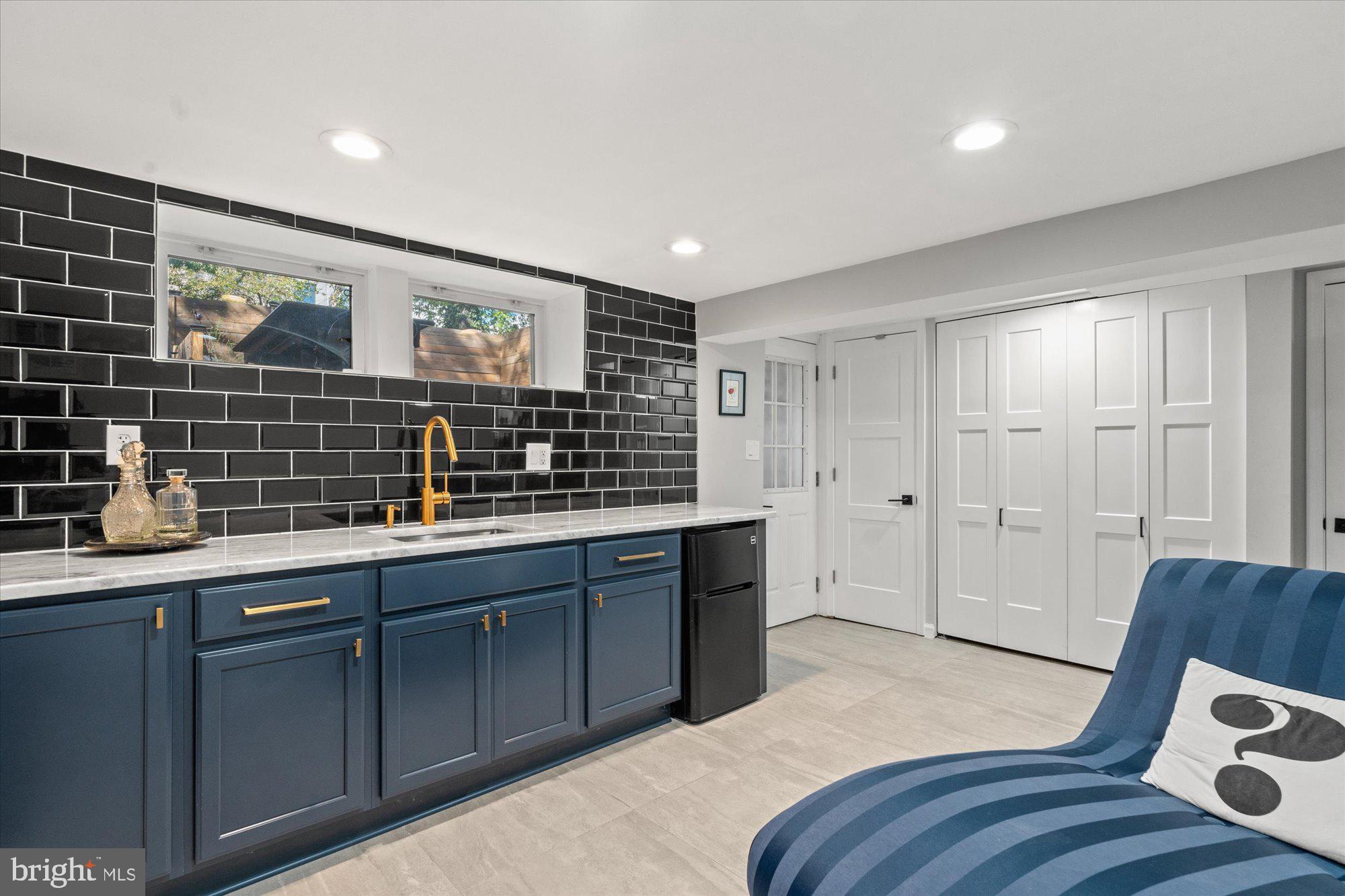 1204 5th Street Northeast Washington, DC 20002 - Photo 36 of 46 a kitchen with stainless steel appliances granite countertop a sink and wooden cabinets