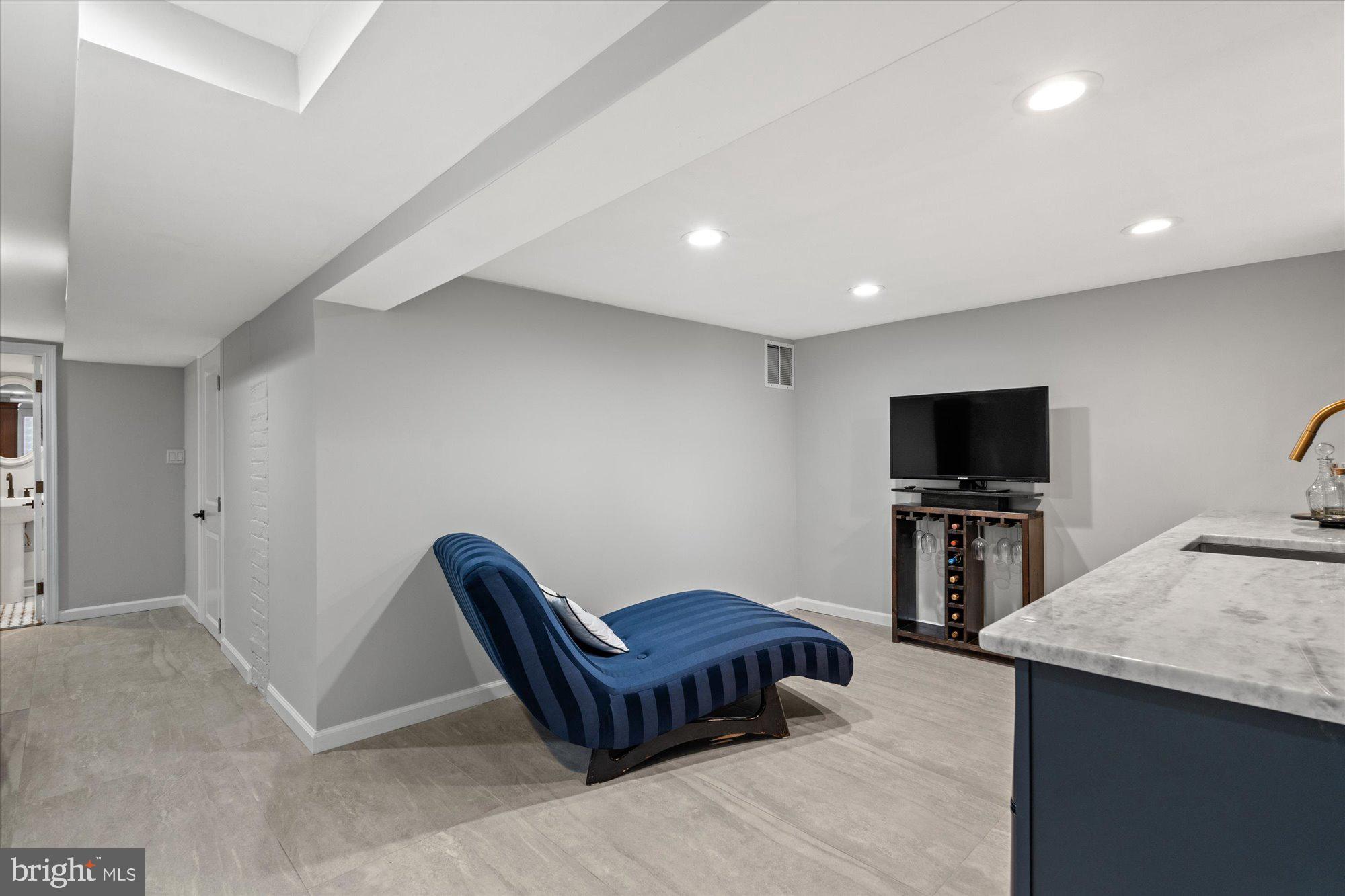 1204 5th Street Northeast Washington, DC 20002 - Photo 37 of 46 a living room with furniture and a flat screen tv