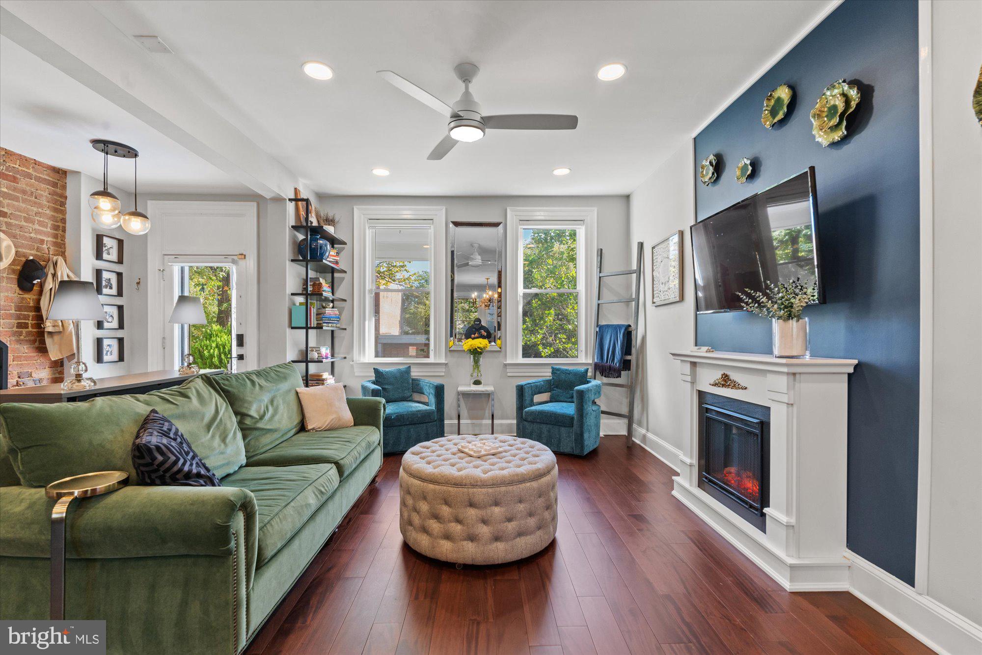 1204 5th Street Northeast Washington, DC 20002 - Photo 7 of 46 a living room with furniture a flat screen tv and a fireplace