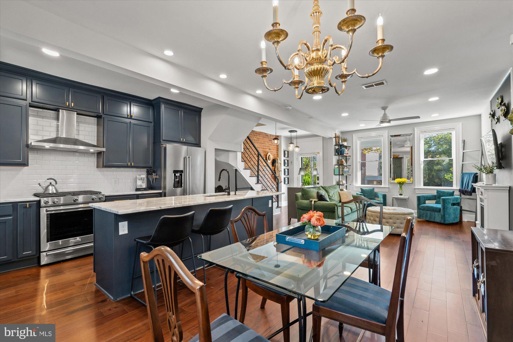 1204 5th Street Northeast Washington, DC 20002 - Photo 9 of 46 a view of a dining room with furniture a kitchen and chandelier