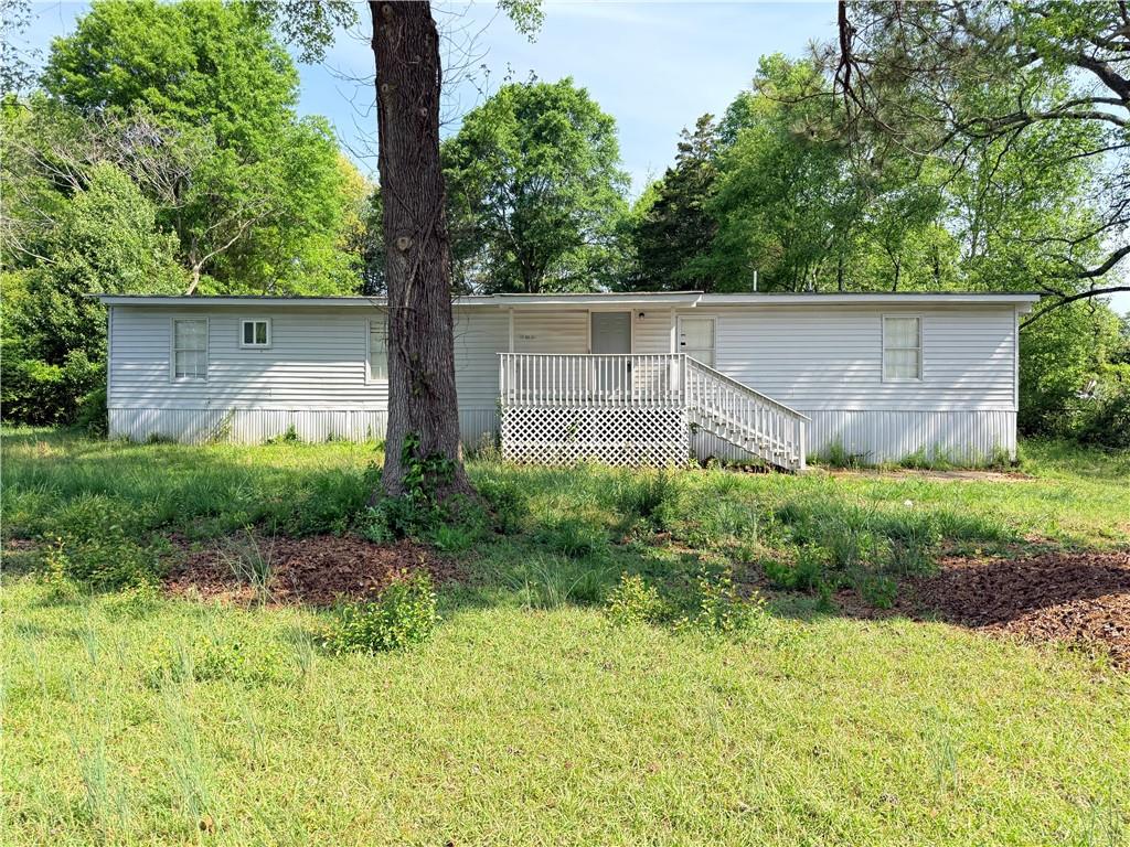 a backyard of a house with plants and large trees