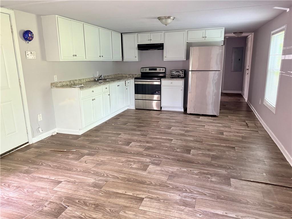 30 Winston Way Hampton, GA 30228 - Photo 3 of 7 a kitchen with stainless steel appliances granite countertop a refrigerator sink and stove