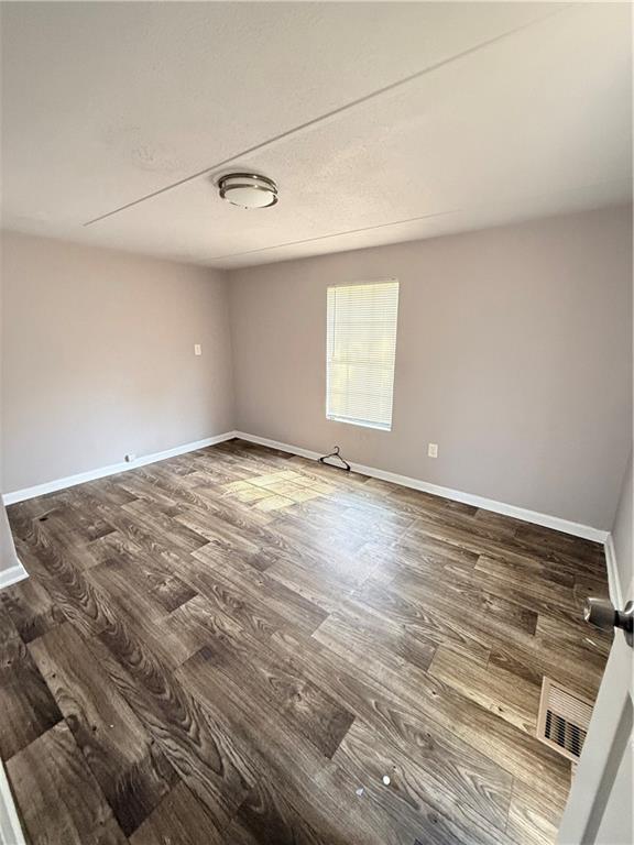 30 Winston Way Hampton, GA 30228 - Photo 6 of 7 an empty room with wooden floor and windows