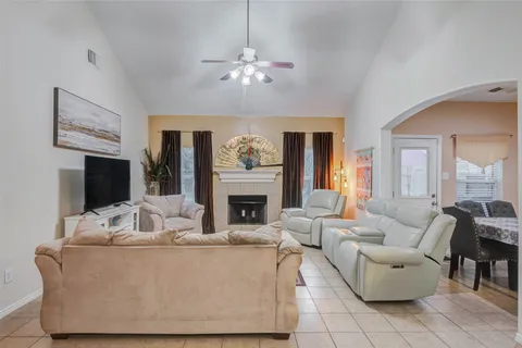 a living room with furniture and a fireplace