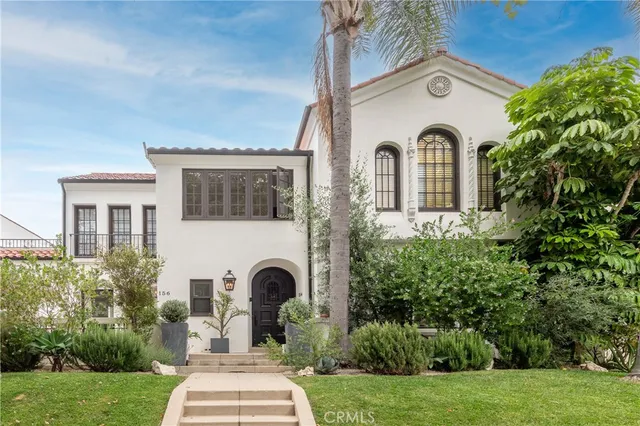 a view of a house with garden and trees