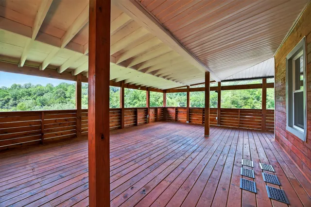 a view of a balcony with wooden floor and fence