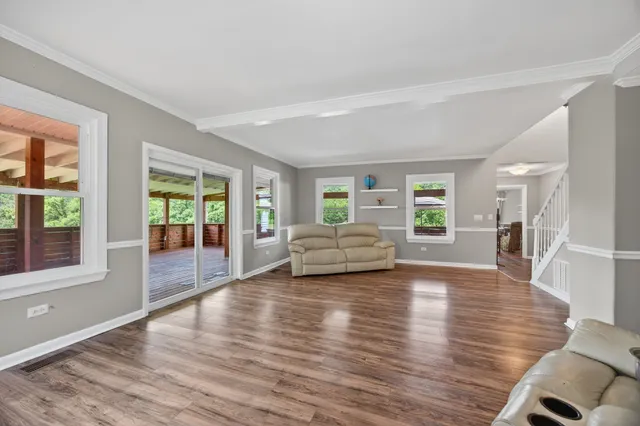 a bedroom with a large bed and a flat tv screen on dresser