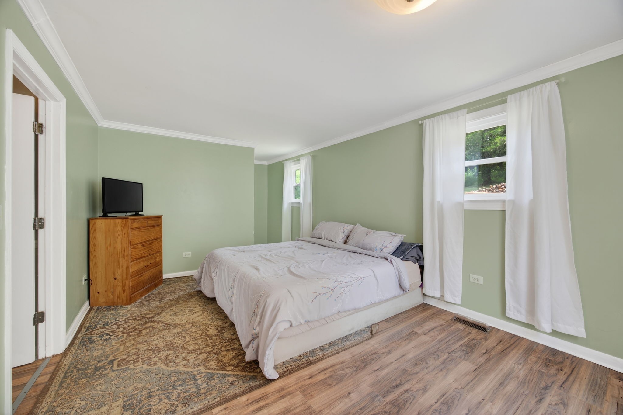 3203 Statesville Road Watertown, TN 37184 - Photo 21 of 56 a bedroom with a large bed and a flat tv screen on dresser