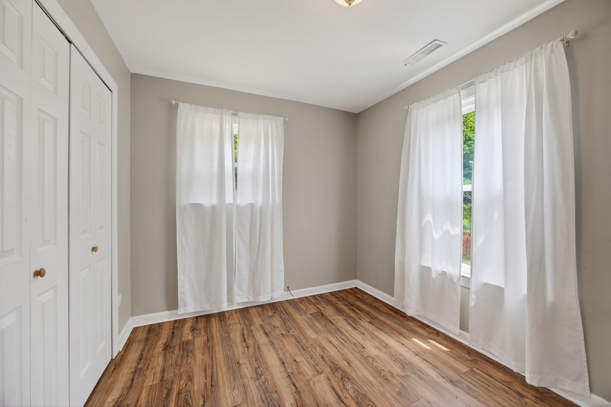 3203 Statesville Road Watertown, TN 37184 - Photo 26 of 56 a view of an empty room with wooden floor and a window