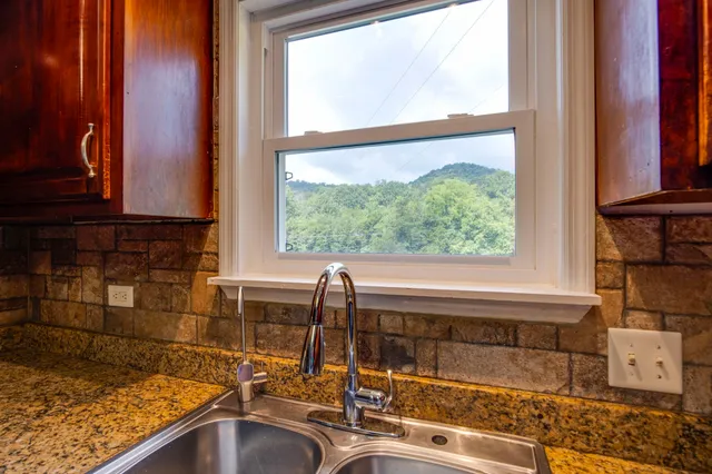 an aerial view of a house with outdoor space and a lake view