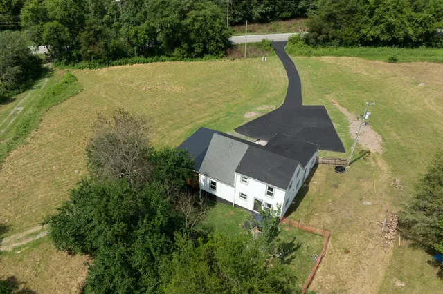 an aerial view of a house with a yard