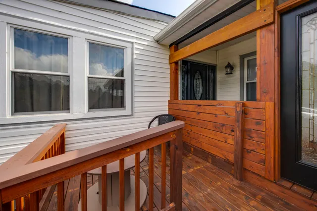 a view of balcony with floor to ceiling window and wooden floor