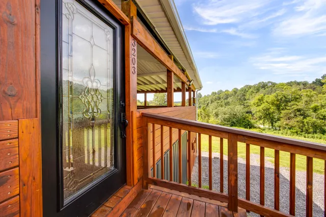 a view of a porch with wooden floor and furniture