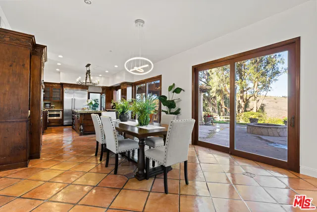 a view of a livingroom with furniture staircase and a kitchen view