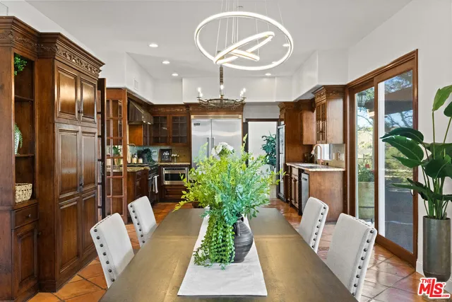 a kitchen with stainless steel appliances granite countertop a sink and wooden cabinets