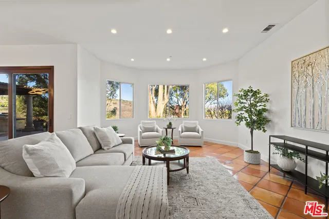 a bathroom with a tub a sink and glass door shower