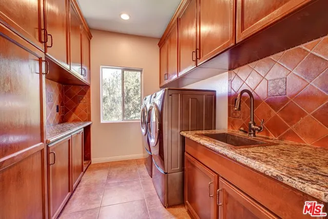 a bathroom with a granite countertop sink a toilet a mirror and shower