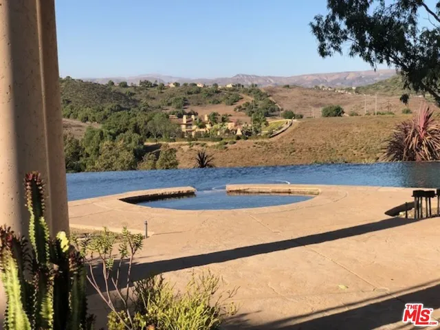 a view of a house with a big yard and large trees