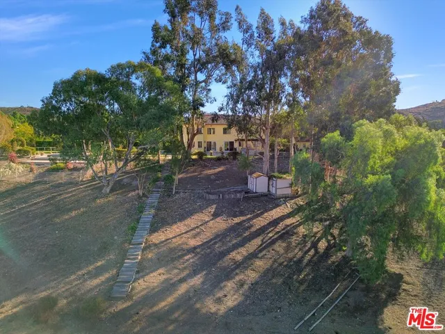 a view of a house with potted plants