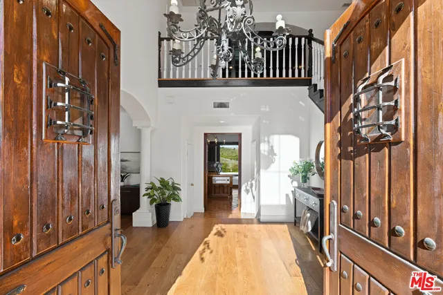 a living room with furniture potted plant a fireplace and a large window