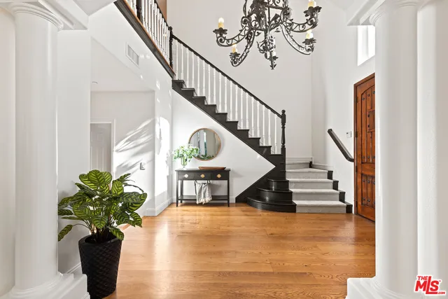 a view of a dining room with furniture wooden floor and chandelier