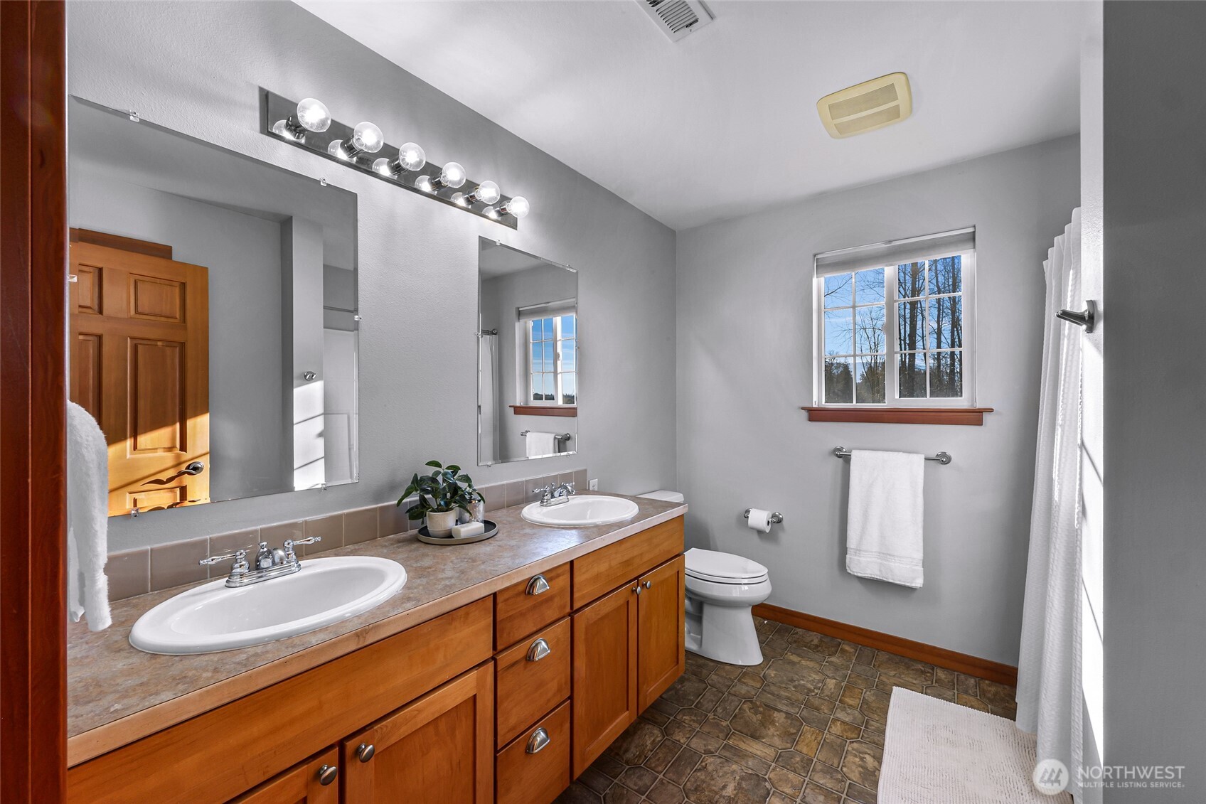 3395 Mack Road Everson, WA 98247 - Photo 33 of 39 a bathroom with a double vanity sink a toilet and a mirror