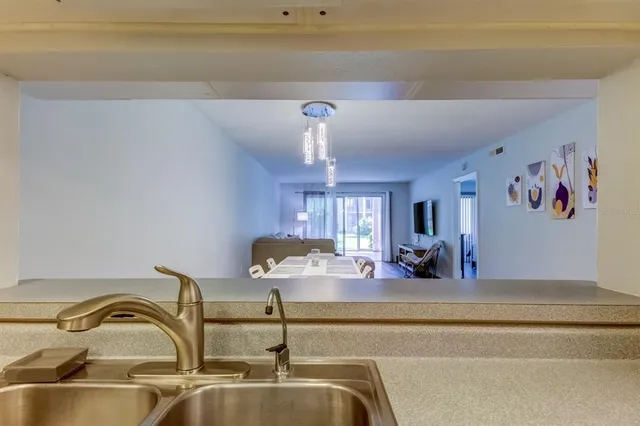 a kitchen with a refrigerator a sink and a stove top oven