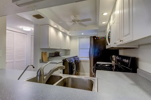 a view of a dining room with furniture a chandelier and wooden floor
