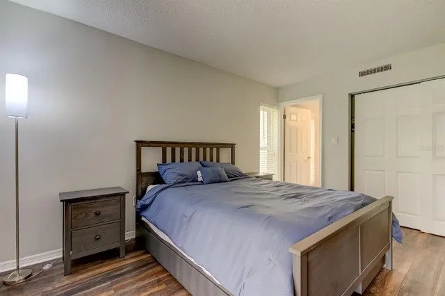 a bathroom with a granite countertop toilet sink and mirror