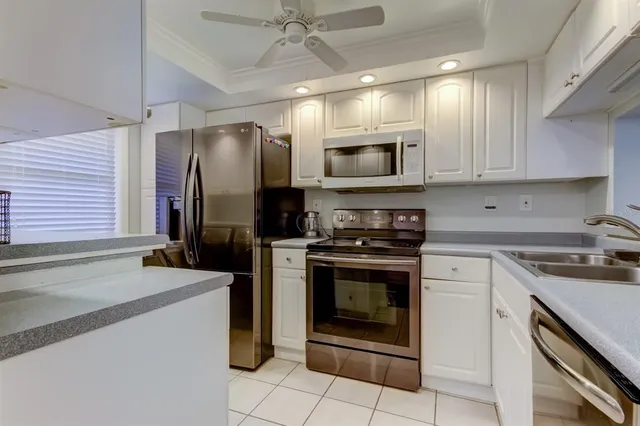 a kitchen with stainless steel appliances granite countertop a stove microwave and refrigerator