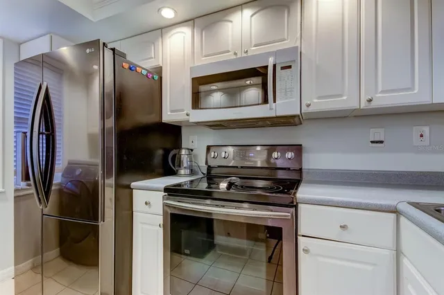 a kitchen with stainless steel appliances and granite countertop