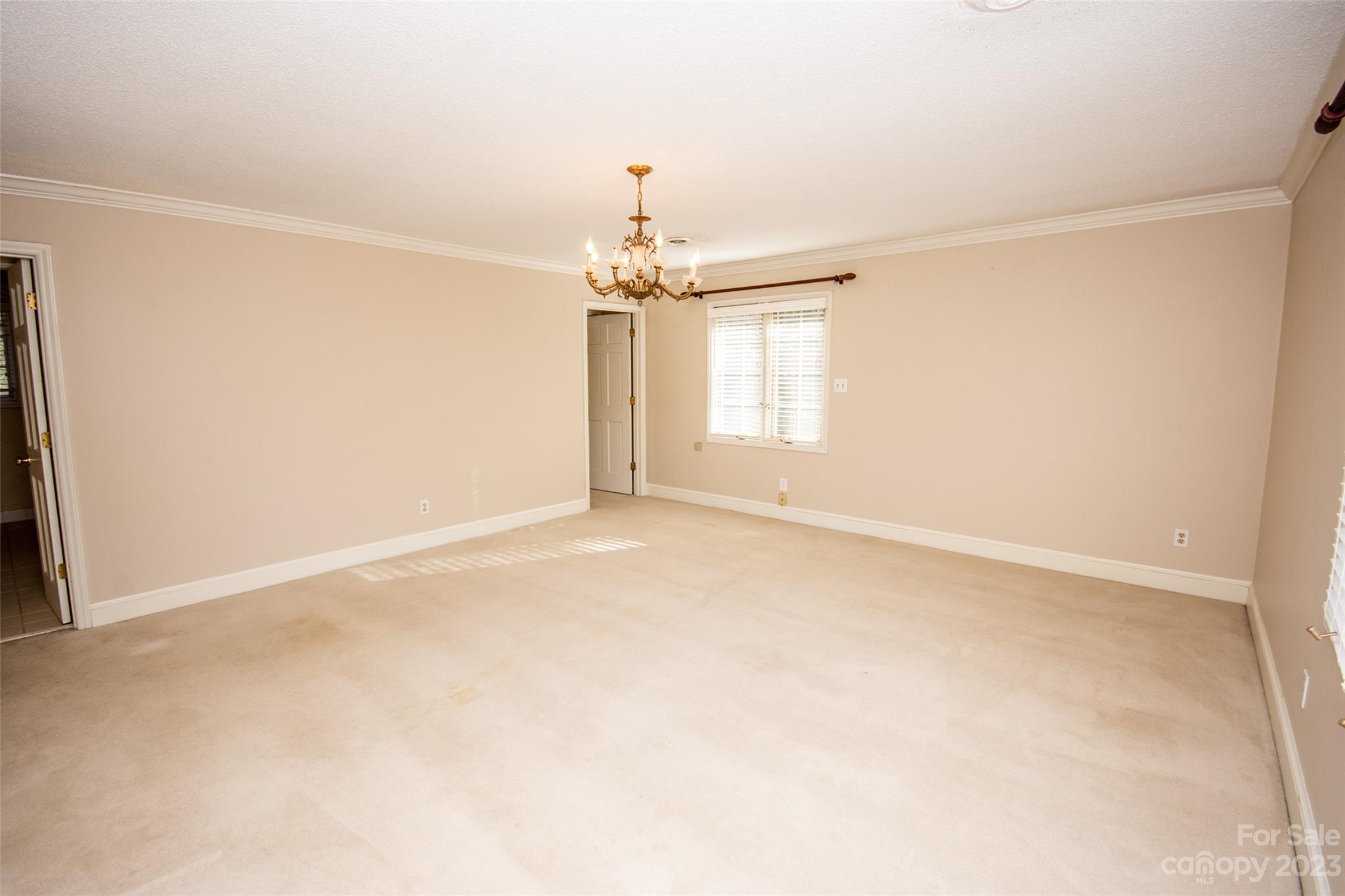 321 St Andrews Road Statesville, NC 28625 - Photo 11 of 19 an empty room with a windows and chandelier