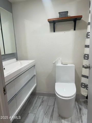 a view of a tennis court with wooden fence