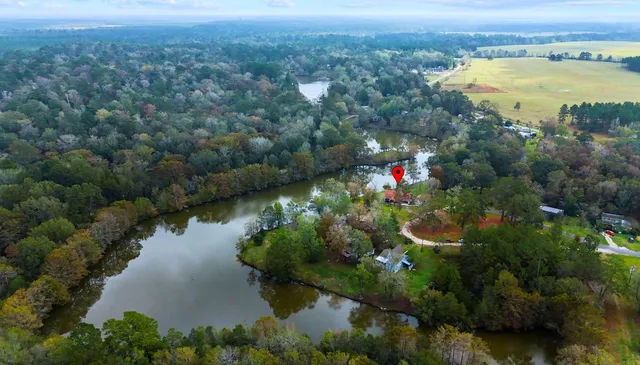 an aerial view of residential houses with outdoor space and swimming pool