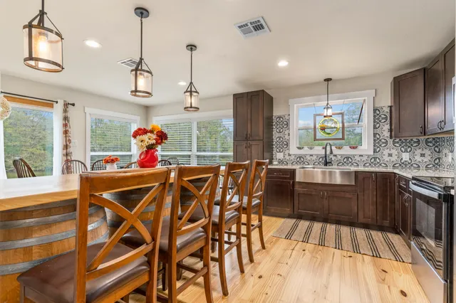 a kitchen with stainless steel appliances a sink stove and cabinets