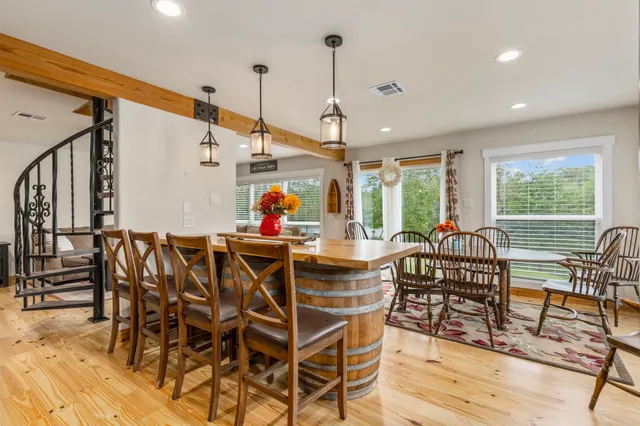a living room with lots of furniture and kitchen view