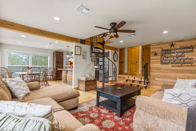 a living room with furniture a fireplace and a table